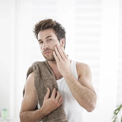 Man checking closeness of shave